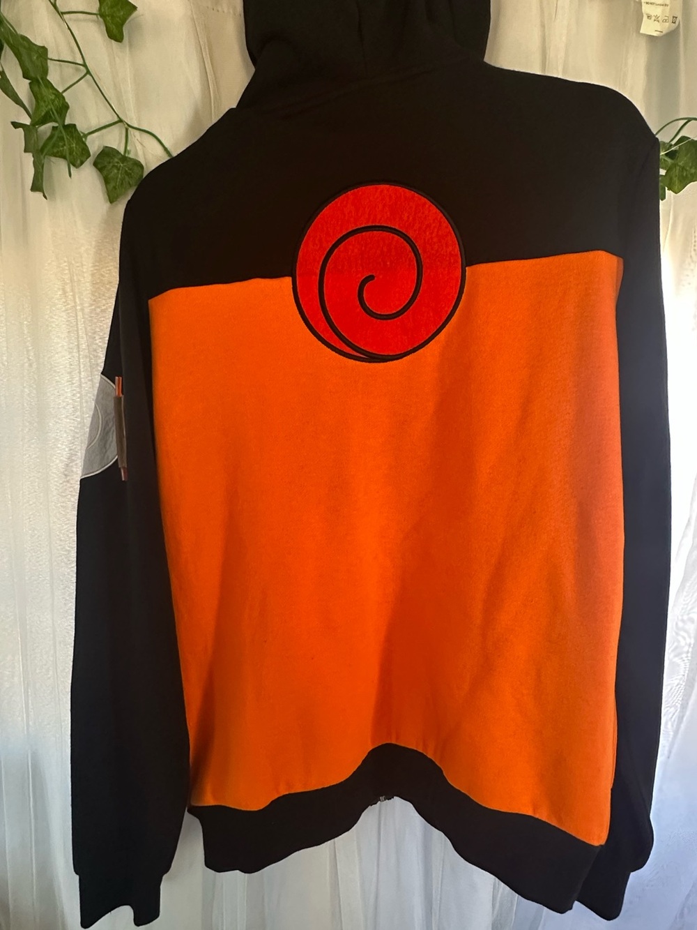 Nurato Men's Black and Orange Crewneck Sweater with Red Spiral Detail